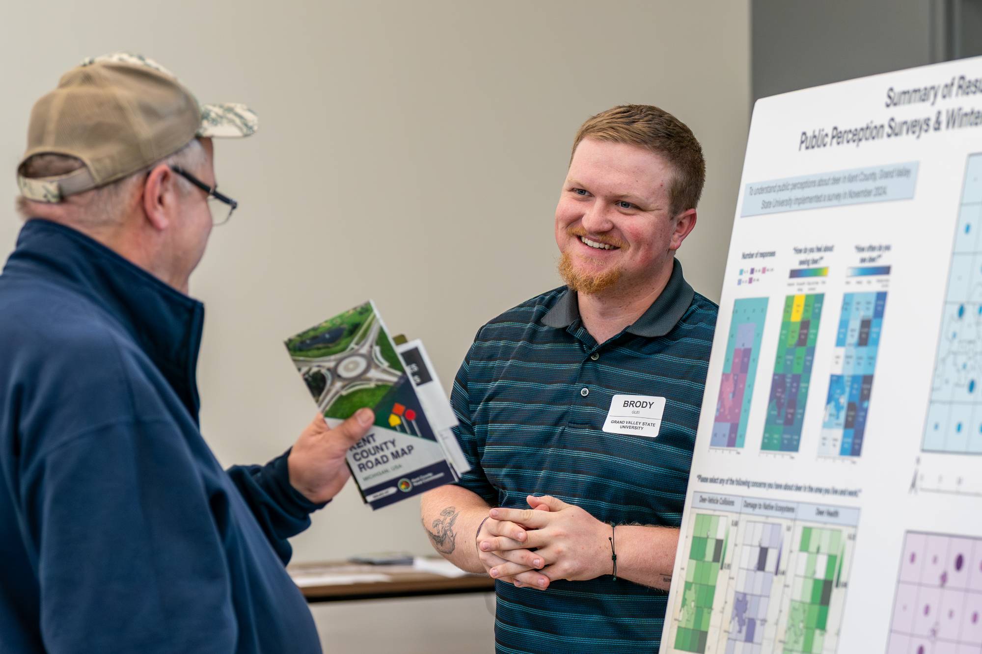 man sharing a poster board presentation